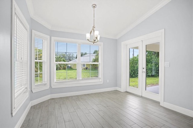 614 Stevenson Ave, Sebastian, FL 32958 - unfurnished dining area with plenty of natural light, a chandelier, crown molding, wood finished floors, and lofted ceiling