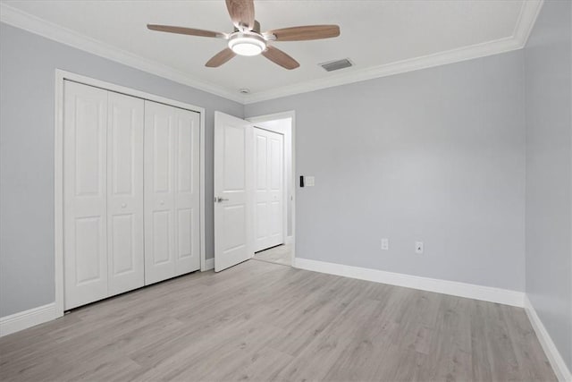 614 Stevenson Ave, Sebastian, FL 32958 - unfurnished bedroom featuring light wood-type flooring, a closet, ornamental molding, and ceiling fan