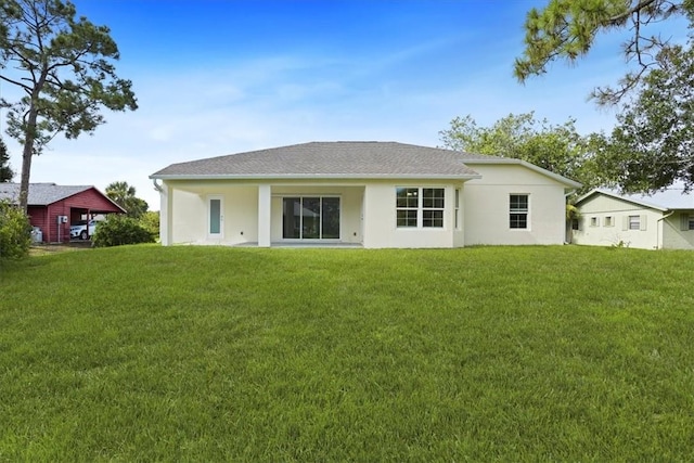 614 Stevenson Ave, Sebastian, FL 32958 - rear view of property featuring stucco siding, a lawn, and a shingled roof