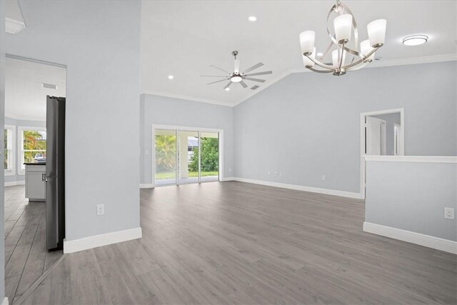 614 Stevenson Ave, Sebastian, FL 32958 - unfurnished living room featuring crown molding, a chandelier, wood finished floors, vaulted ceiling, and a ceiling fan