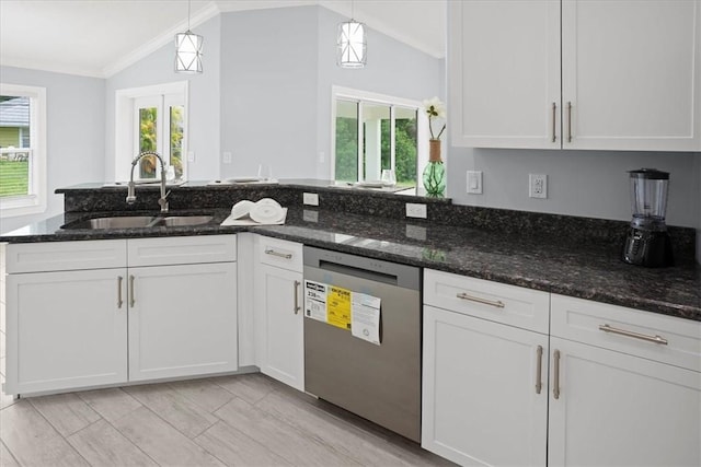 614 Stevenson Ave, Sebastian, FL 32958 - kitchen with vaulted ceiling, stainless steel dishwasher, white cabinets, dark stone countertops, and hanging light fixtures