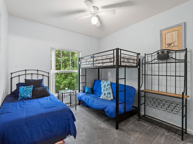 bedroom with carpet flooring, a textured ceiling, and ceiling fan