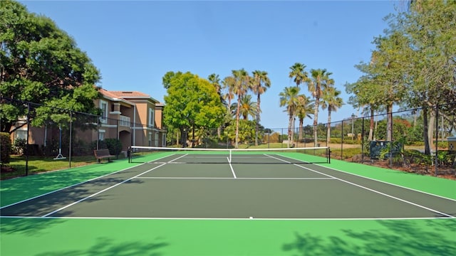 view of tennis court with basketball hoop