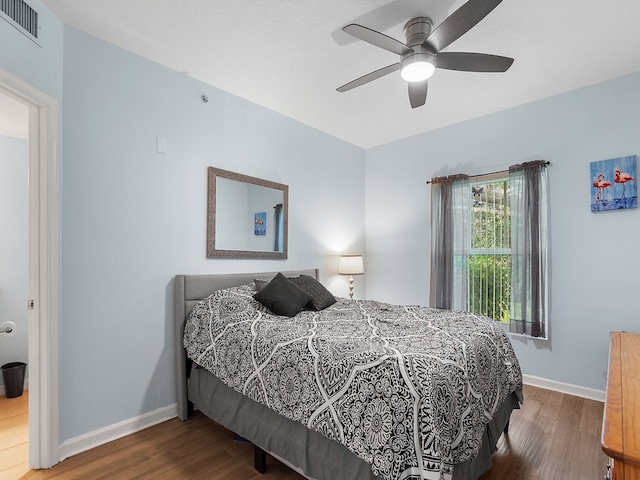 bedroom with hardwood / wood-style flooring and ceiling fan