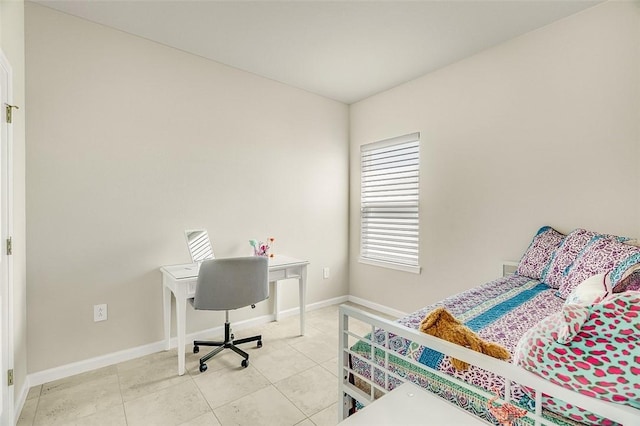 bedroom with light tile patterned flooring and baseboards