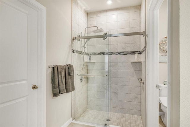 bathroom with toilet and a shower stall