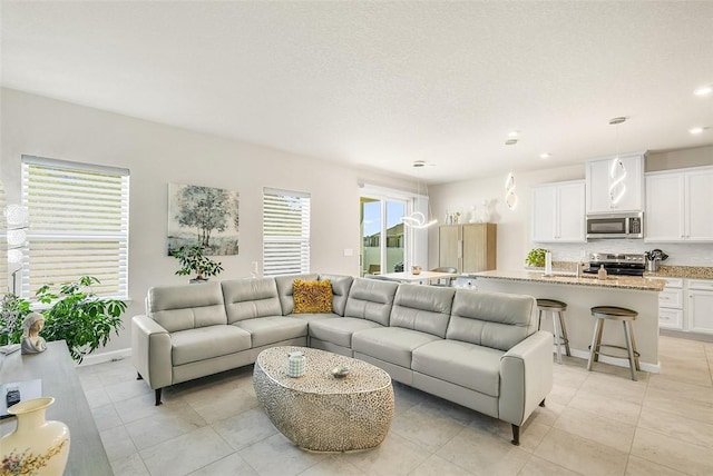 living area with light tile patterned floors and recessed lighting