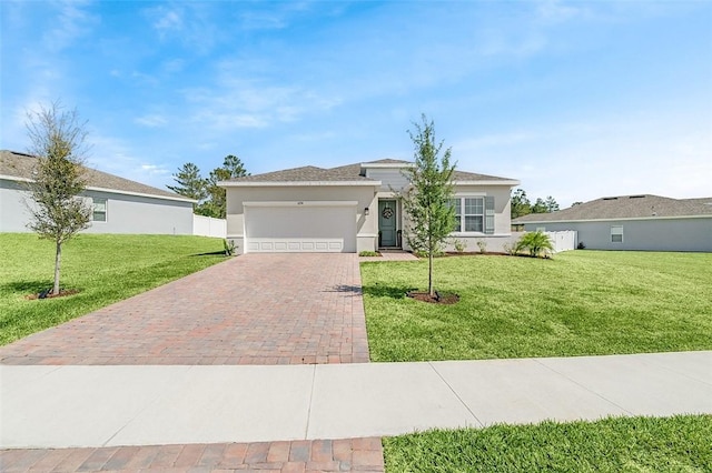 view of front of home featuring a front yard, a garage, driveway, and stucco siding