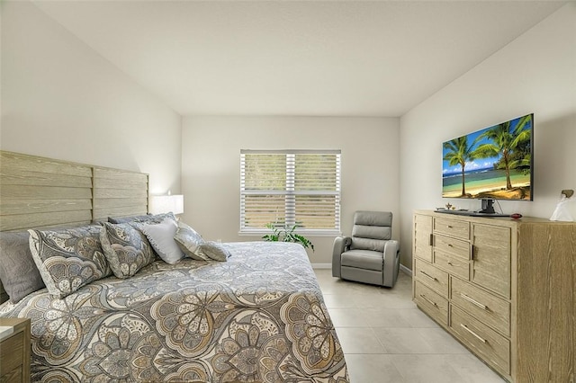 bedroom with light tile patterned floors and baseboards