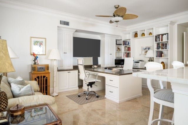 home office with visible vents, crown molding, ceiling fan, built in features, and built in desk