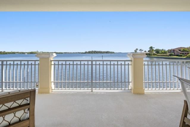 view of patio with a water view and a balcony