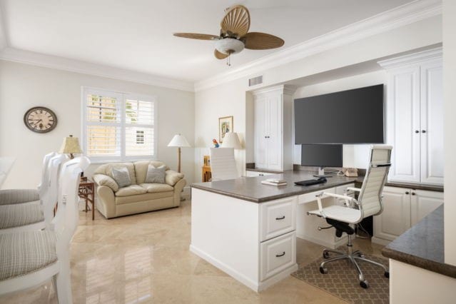 office area featuring ceiling fan, visible vents, and ornamental molding