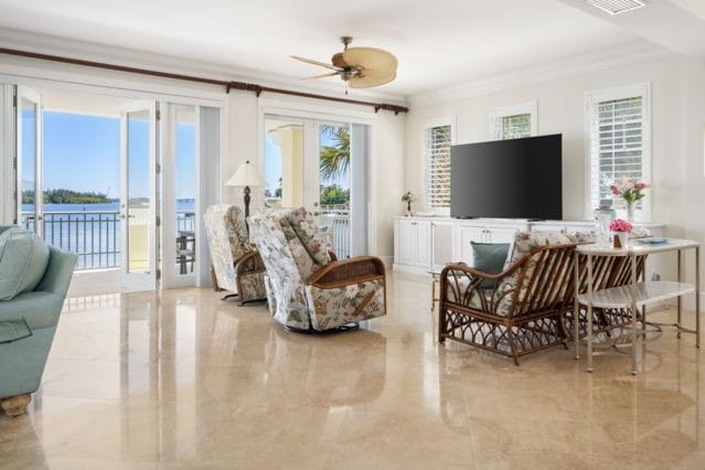 living room with marble finish floor, crown molding, and a ceiling fan