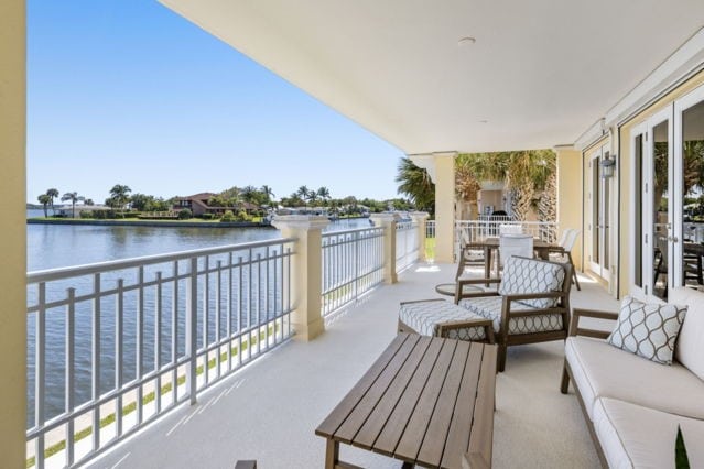 balcony with outdoor dining area, an outdoor hangout area, and a water view