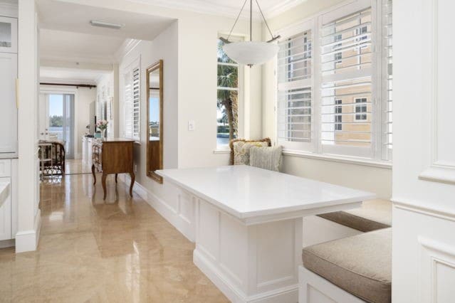 dining area with marble finish floor and ornamental molding