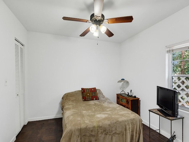 bedroom with ceiling fan and a closet