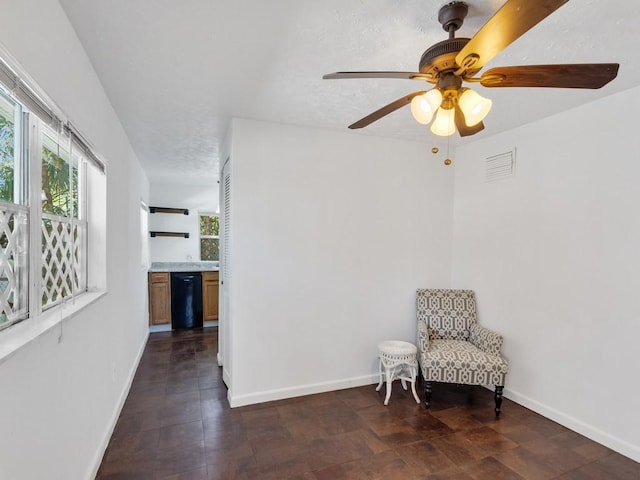 sitting room featuring a textured ceiling and ceiling fan