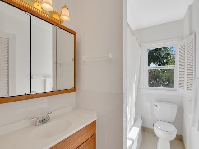 full bathroom with vanity, toilet, shower / tub combo, and tile walls