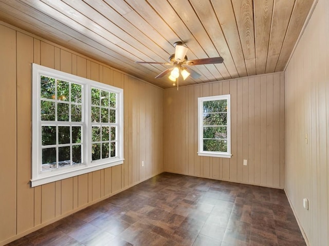 unfurnished room with ceiling fan and wooden ceiling