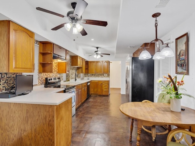 kitchen featuring extractor fan, decorative light fixtures, kitchen peninsula, stainless steel appliances, and decorative backsplash