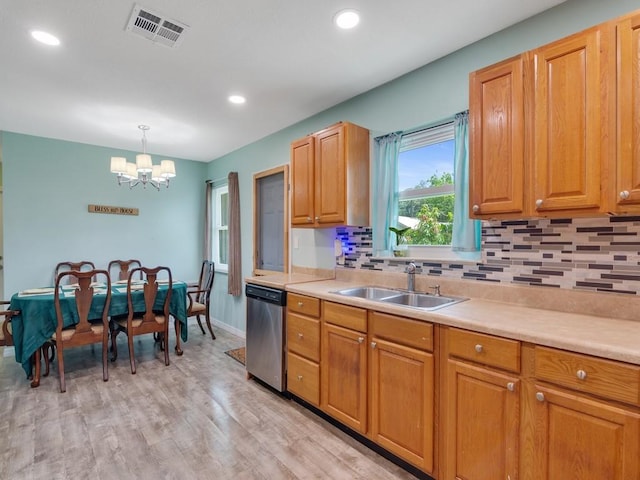432 Watercrest St, Sebastian, FL 32958 - kitchen with dishwasher, a chandelier, tasteful backsplash, light countertops, and light wood-style flooring