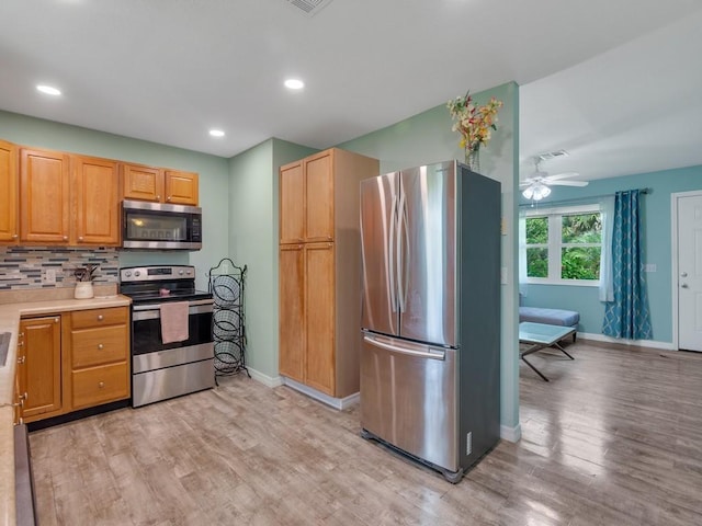 432 Watercrest St, Sebastian, FL 32958 - kitchen with appliances with stainless steel finishes, light wood finished floors, backsplash, recessed lighting, and ceiling fan