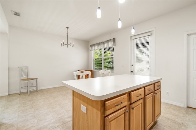 kitchen featuring a kitchen island, pendant lighting, and a chandelier