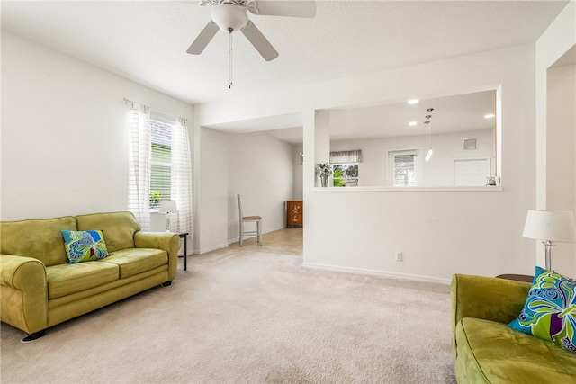 living room featuring ceiling fan and light colored carpet