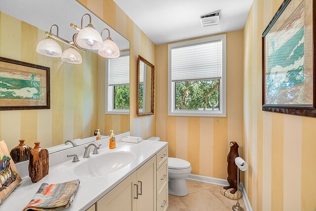 bathroom featuring tile patterned flooring, vanity, and toilet