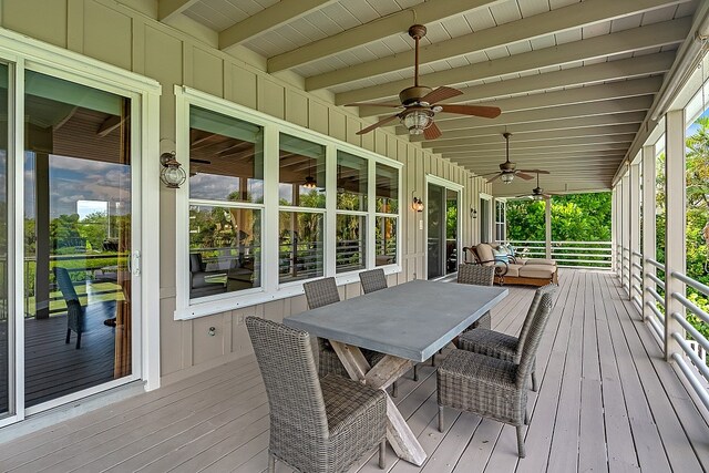 wooden deck featuring ceiling fan