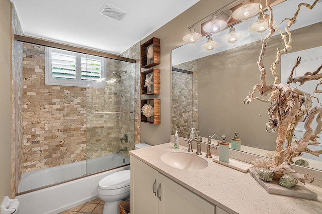 full bathroom featuring toilet, enclosed tub / shower combo, tile patterned floors, and vanity