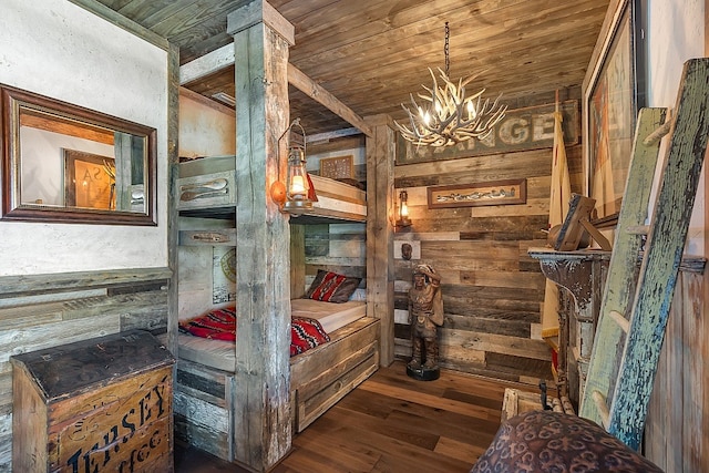 bedroom with dark wood-type flooring, wooden walls, and wooden ceiling