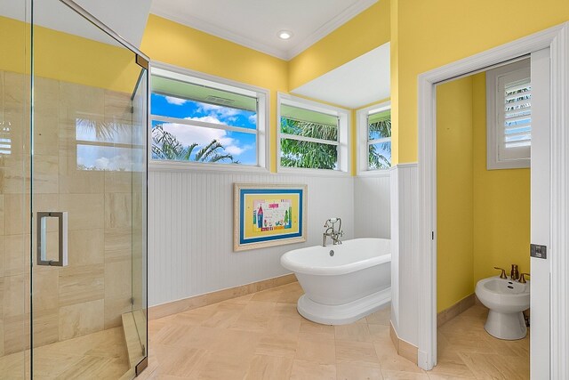 bathroom featuring a bidet, crown molding, and separate shower and tub