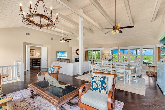 living room with ceiling fan with notable chandelier, dark wood-type flooring, a healthy amount of sunlight, and wooden ceiling