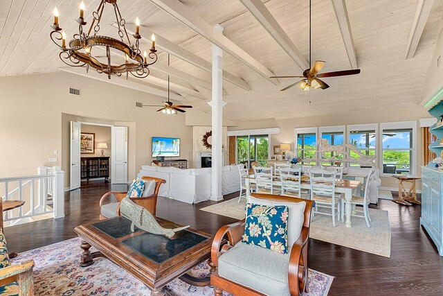 living room with ceiling fan with notable chandelier, dark wood-type flooring, a healthy amount of sunlight, and wooden ceiling