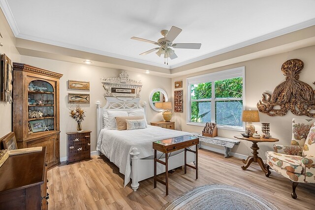 bedroom with light hardwood / wood-style floors, ceiling fan, and crown molding