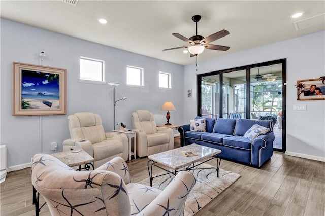 living room with ceiling fan and light wood-type flooring