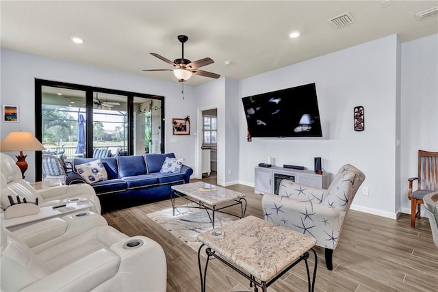 living room with hardwood / wood-style flooring and ceiling fan