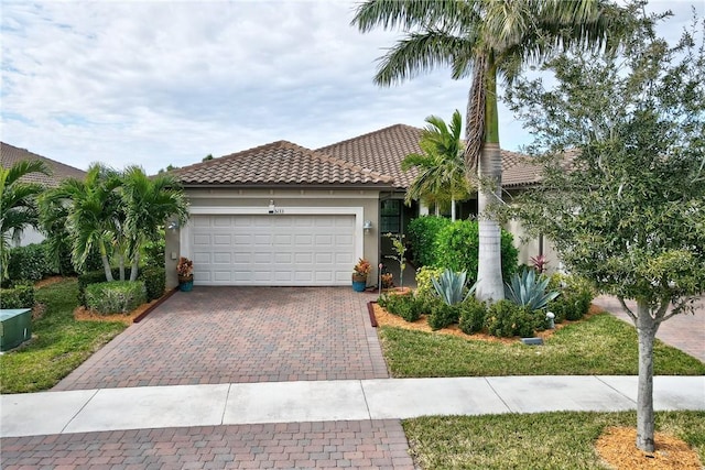 mediterranean / spanish-style home with a garage