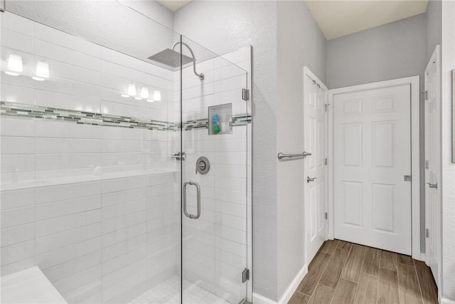 bathroom featuring a shower with shower door