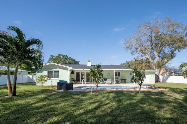 back of house with a patio area, a yard, and a fenced in pool