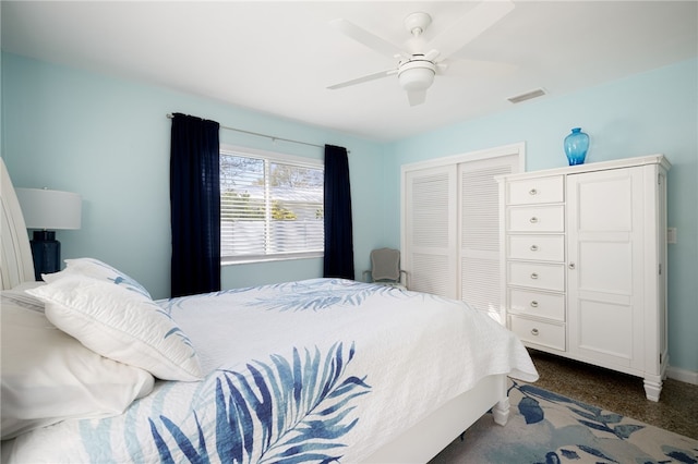 bedroom with dark colored carpet, a closet, and ceiling fan