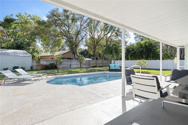 view of swimming pool featuring a patio area and a lawn