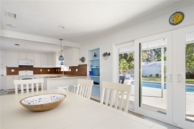 tiled dining space with ornamental molding and sink