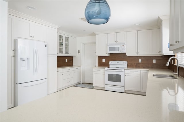 kitchen featuring white cabinets, white appliances, tasteful backsplash, and sink