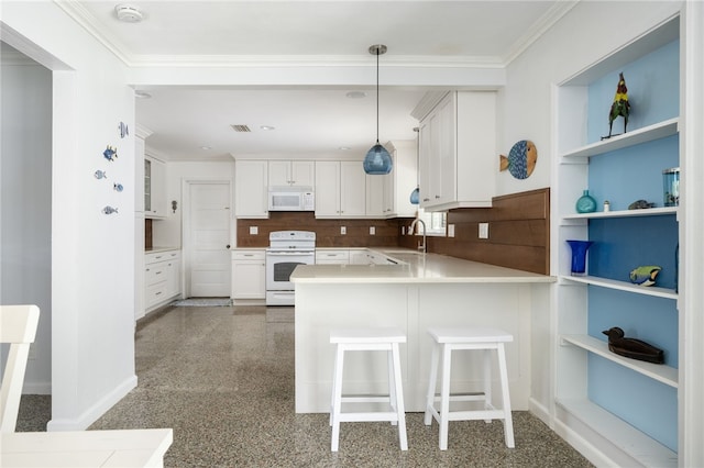 kitchen with white appliances, white cabinets, hanging light fixtures, decorative backsplash, and kitchen peninsula