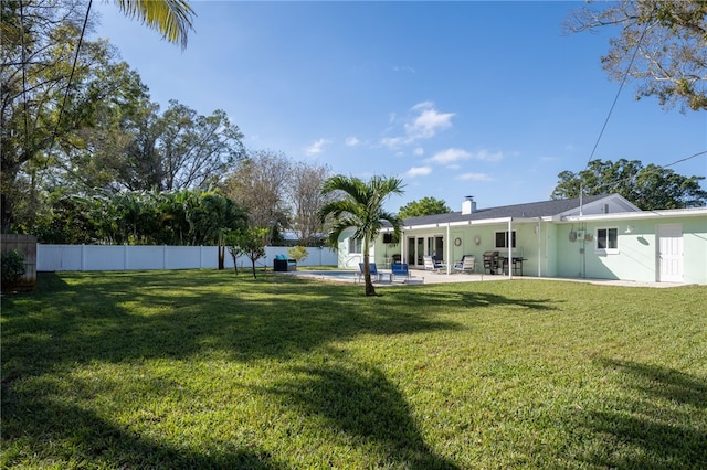 view of yard featuring a fenced in pool and a patio