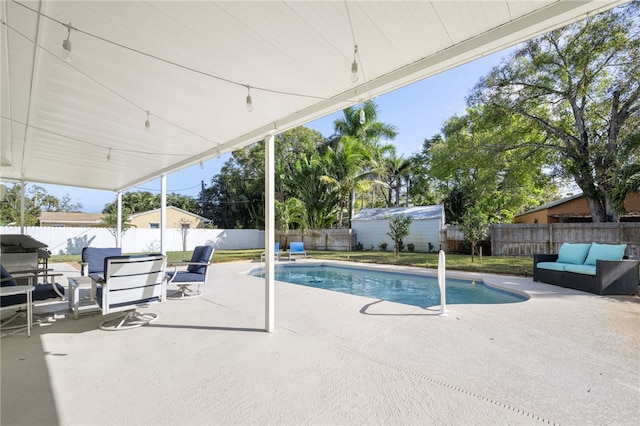 view of pool with outdoor lounge area and a patio