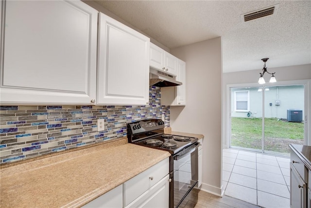 kitchen featuring visible vents, white cabinets, black range with electric stovetop, hanging light fixtures, and light countertops