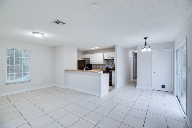 kitchen with visible vents, hanging light fixtures, white cabinetry, a peninsula, and black appliances